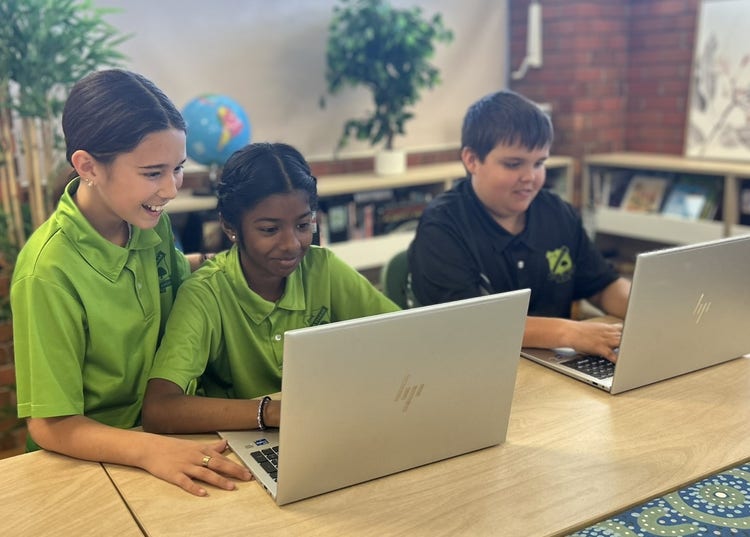 3 students on laptops