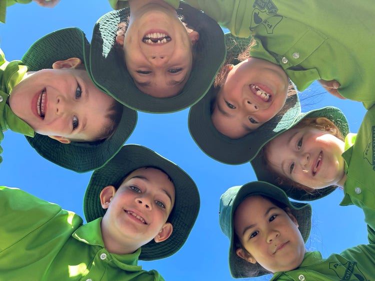 students smiling in a circle