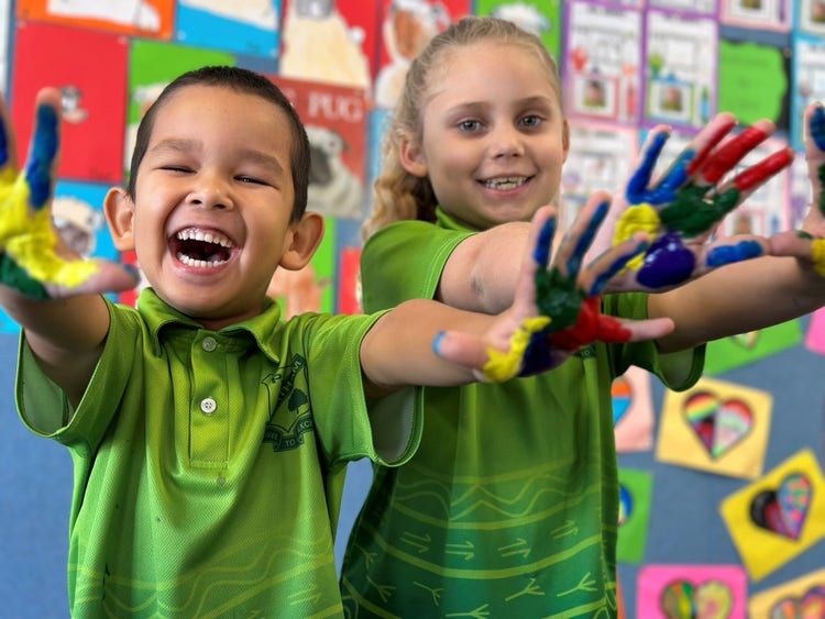 two students with paint on their hands