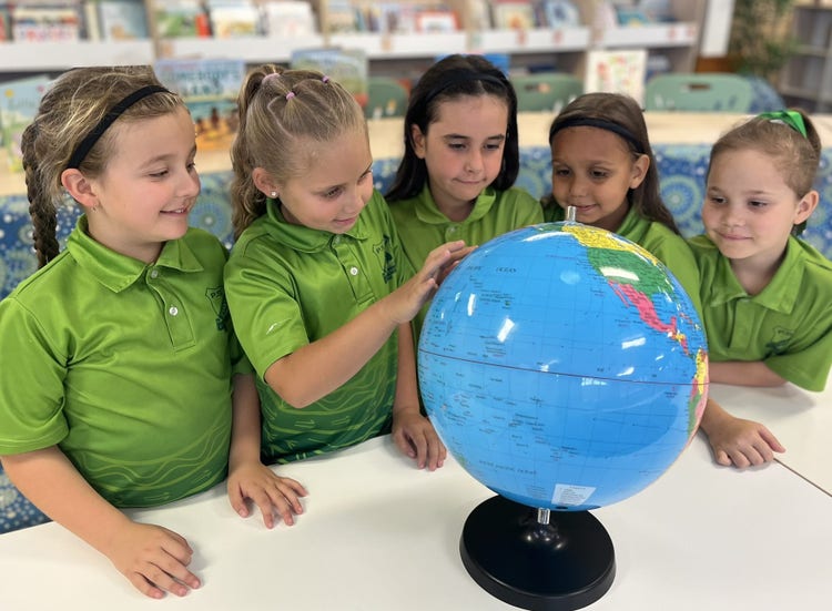 students with a world globe