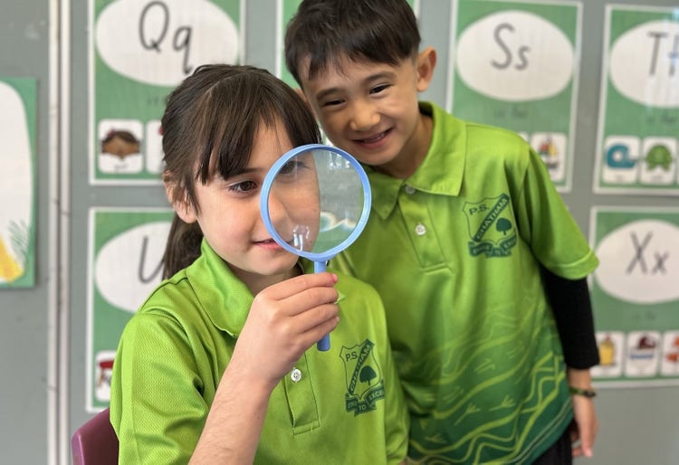 students with magnifying glass